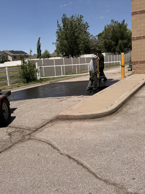 Crew repairing residential street pavement